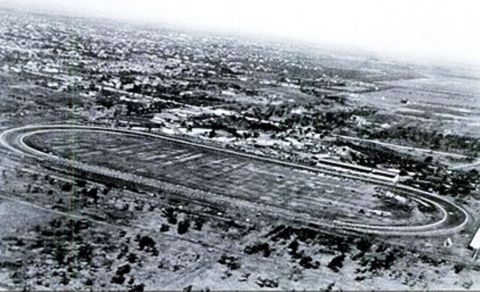 1909 Ford Model T - An aerial perspective captures a horse racing track surrounded by a town and open land.