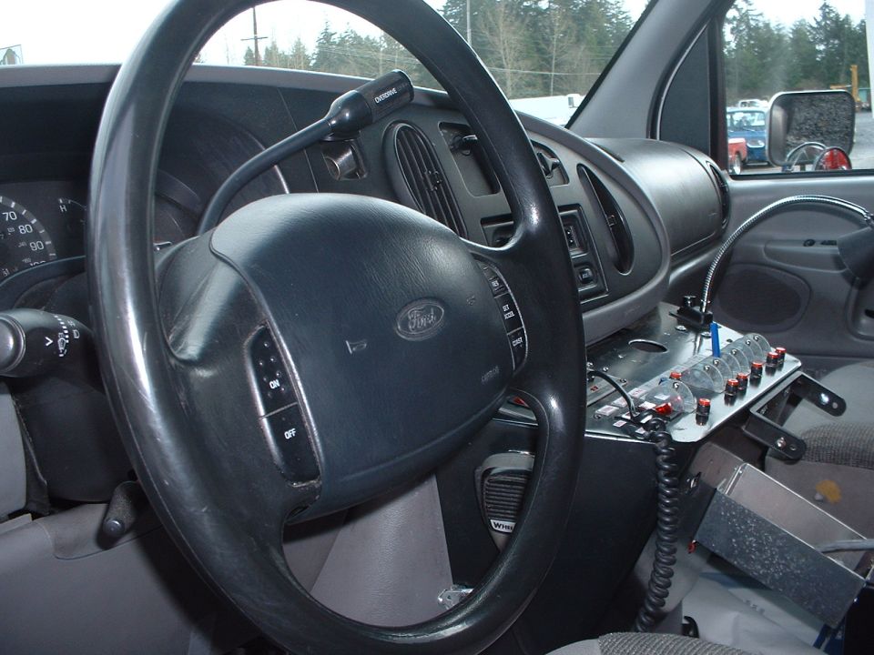 Van interior with steering wheel, dashboard, and control panel