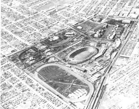 1909 Ford Model T - An aerial perspective captures a large stadium and its adjacent urban development, marked by a website watermark.