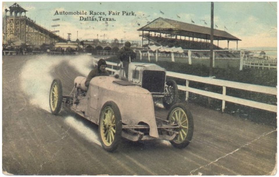 Two open-wheel race cars on a dirt track, one kicking up dust. Text reads 'Automobile Races, Fair Park, Dallas, Texas.'
