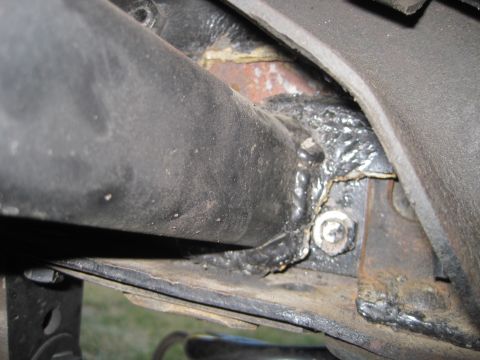 1989 Ford Bronco - Detail of a welded frame section, showing a bolted connection and rough weld work.