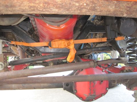 1989 Ford Bronco - Close-up of vehicle undercarriage, focusing on the drivetrain and suspension parts.