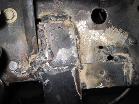 1989 Ford Bronco - This image shows a section of a vehicle's frame that has undergone extensive welding repairs.