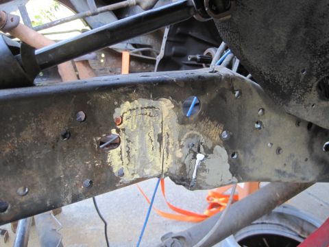 1989 Ford Bronco - This is a close-up view of a vehicle's frame, showing areas that have been repaired and prepped for further work.
