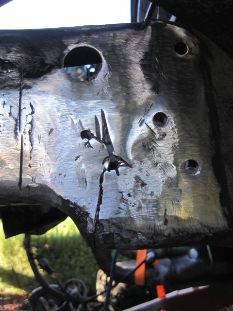 1989 Ford Bronco - This is a close-up view of a vehicle's metal frame, showing areas that have been ground down and possibly welded.
