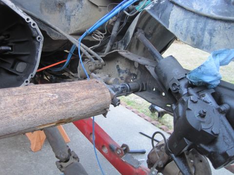 1989 Ford Bronco - Close-up view of a vehicle's driveshaft and steering gear assembly, likely undergoing maintenance or repair.
