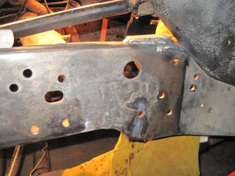 1989 Ford Bronco - Frame rail shows signs of repair with new welds and drilled holes.