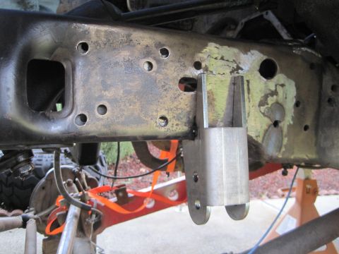 1989 Ford Bronco - A close-up view shows a modified vehicle frame with a newly installed bracket, suggesting custom suspension work.