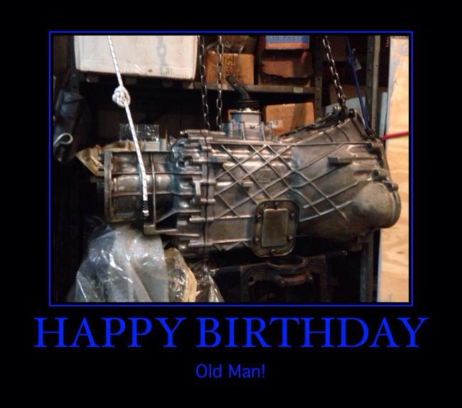 transmission hanging from chains in a garage, text says HAPPY BIRTHDAY Old Man!