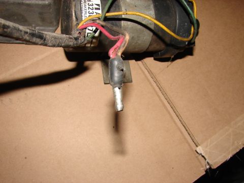 1973 Ford Ranchero - Close-up of an automotive electrical component with visible wiring and a metal connector.