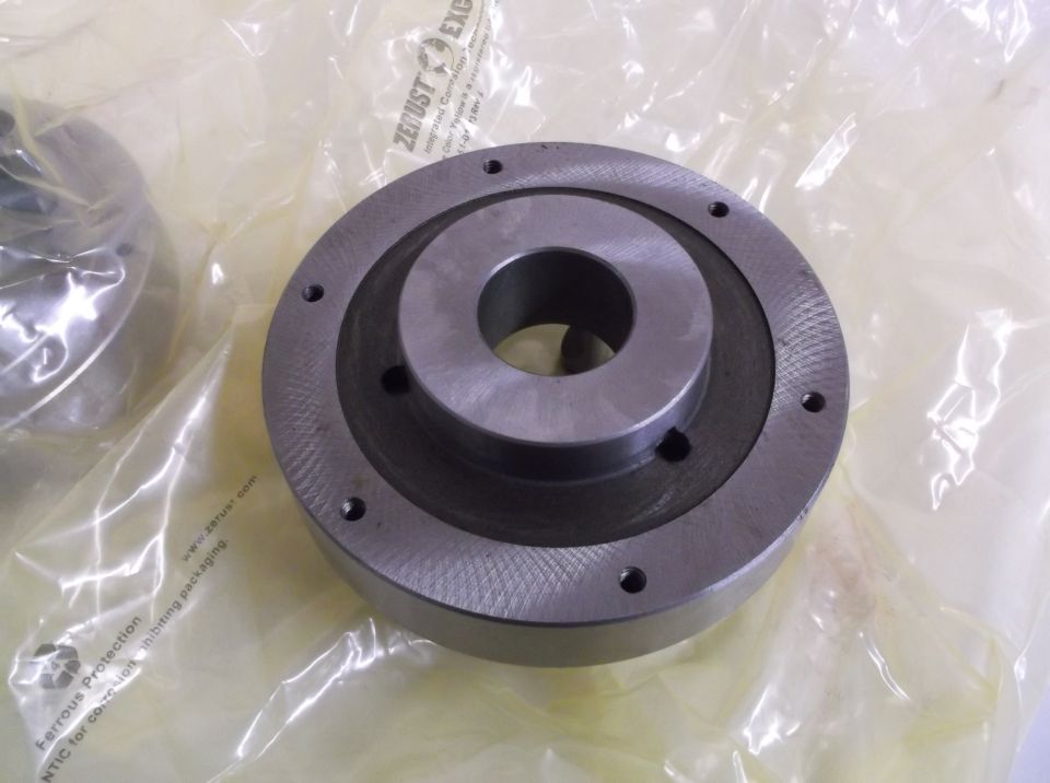 metal pulley or hub with bolt holes, in plastic packaging