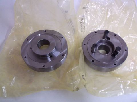 1995 Mercury Grand Marquis - Two metal chucks are shown, one with three pins, both wrapped in plastic packaging.