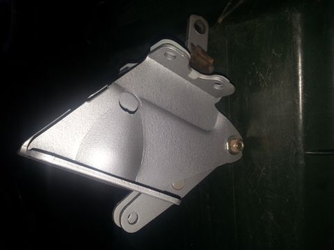 1973 Ford F-100 - A metal bracket is shown in detail, mounted against a dark surface.