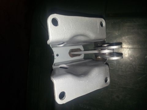 1973 Ford F-100 - A metal door hinge assembly is shown against a dark background.