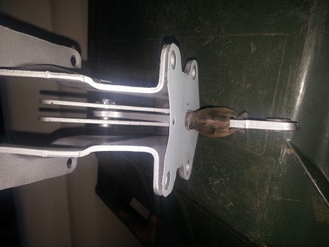 1973 Ford F-100 - Detail of a vehicle's parking brake lever mechanism, showing the linkage and wooden handle.
