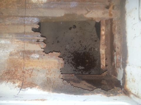 1973 Ford F-100 - Significant rust and corrosion have compromised this vehicle's frame, creating a large opening.