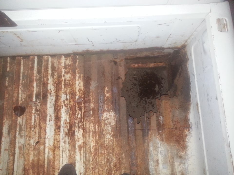 rusted truck bed with visible damage and wear