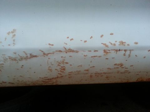 1973 Ford F-100 - Rust spots are visible on a white painted surface, suggesting potential corrosion.