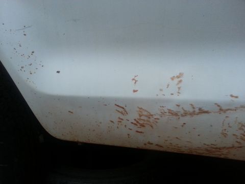 1973 Ford F-100 - Dirt and mud marks are visible on the lower section of a white vehicle's body panel.