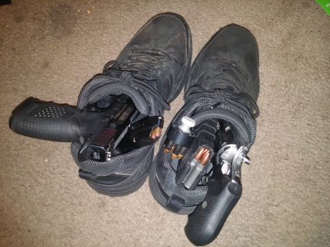 2000 Mercury Grand Marquis - Guns and ammunition are hidden inside a pair of black shoes.