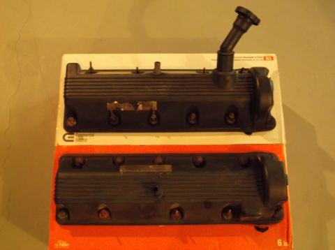 1995 Mercury Grand Marquis - Two engine valve covers are displayed on a box, one with an oil cap attached.