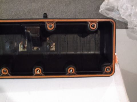 1995 Mercury Grand Marquis - Close-up of a valve cover gasket with an orange seal and mounting holes.