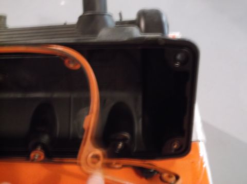 1995 Mercury Grand Marquis - Close-up of an engine valve cover gasket and the exposed engine parts beneath it.