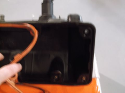 1995 Mercury Grand Marquis - A hand holds a valve cover with an orange gasket, ready for installation or removal.