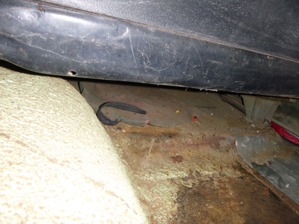 Interior floor pan with rust and wiring visible