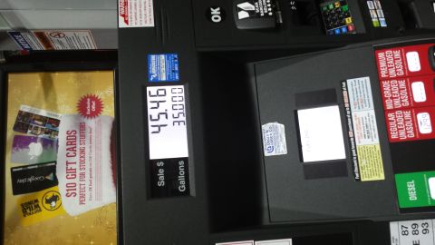 1995 Ford Bronco - A gas pump display shows a sale of $45.46 for 35.000 gallons, with various advertisements visible.