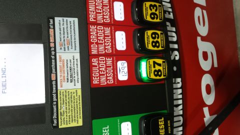 1995 Ford Bronco - A gas pump display shows prices for regular, mid-grade, and premium unleaded gasoline, with the 87 octane button illuminated.