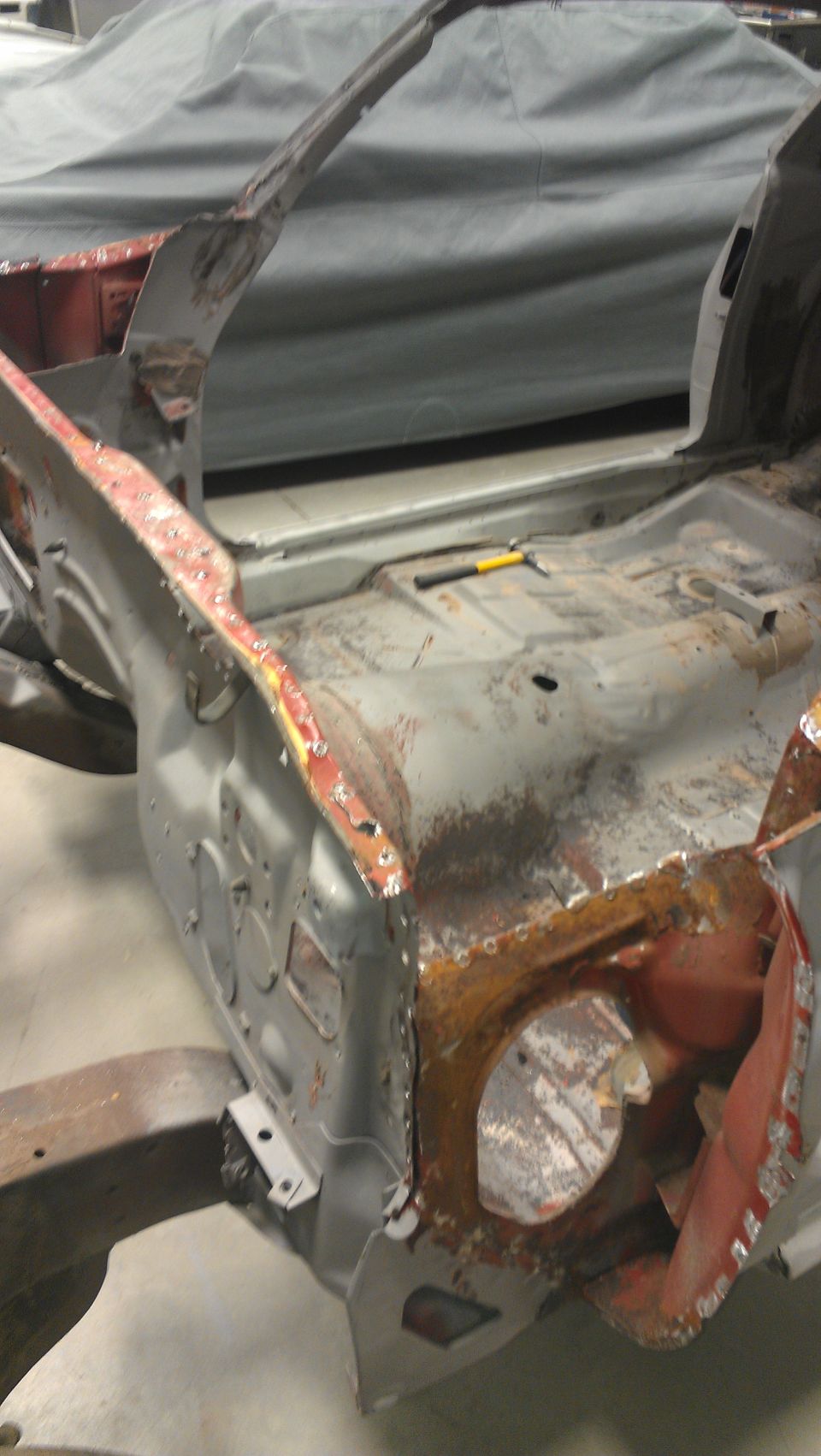 1970 Pontiac Trans Am body shell, stripped down for restoration. Floor pan and inner fenders are visible