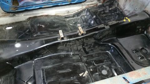 1970 Pontiac Trans Am - Interior floor pan of a car undergoing restoration, showing bare metal and some protective coating.