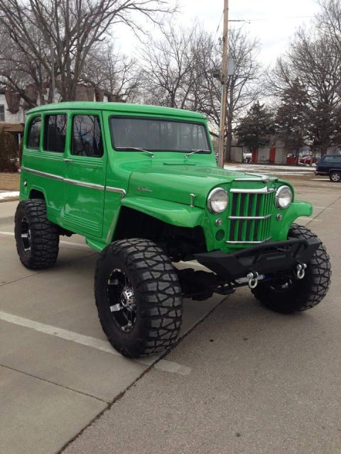 1986 Ford Bronco - This lifted Jeep Willys wagon is painted bright green and sits on massive off-road tires.