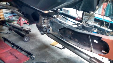 1967 Ford F-250 - Close-up view of a truck's undercarriage, showing frame modifications and suspension components.