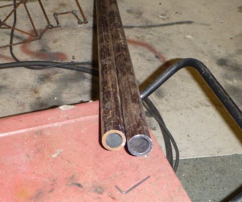1964 Mercury Monterey - Two metal pipes and a portion of a black metal frame are visible in this close-up view.