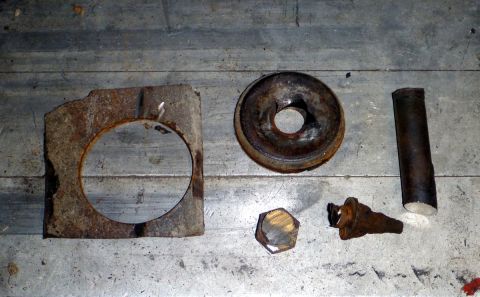 1964 Mercury Monterey - Collection of assorted rusty automotive parts laid out on a metallic surface.