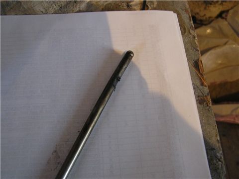 1993 Ford Bronco - A metal rod is placed on a sheet of paper with faint grid lines visible.