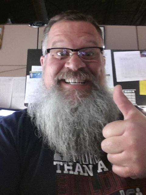 1973 Ford F-100 - A man with a large beard and glasses smiles and gives a thumbs-up gesture.