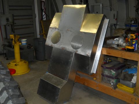 1992 Ford Bronco - A partially constructed metal object resembling a robotic torso or a large component is shown in a workshop setting. The object is made of…