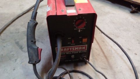 1995 Ford Bronco - A red and black Craftsman wire feed welder is shown with its welding gun and cables. The welder has controls for wire feed speed, voltage,…