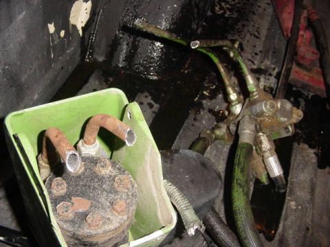 1992 Ford Bronco - This image shows a hydraulic pump assembly with connected hoses, likely from a vehicle's power steering or similar system.