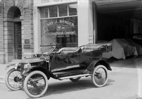 1914 Ford Model T - 1914 Ford Model T touring car in front of Henry J. Ranger Ford Motor Company dealership.