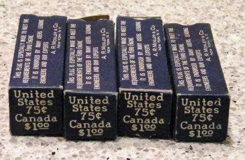 1915 Ford Model T - Four blue cardboard boxes are lined up, each with white text printed vertically and horizontally. The text on the boxes indicates they are…