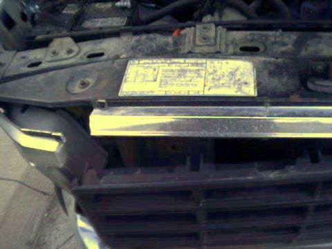1981 Ford Bronco - Close-up of a vehicle's engine bay, showing a sticker and part of the grille.