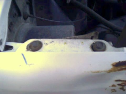 1981 Ford Bronco - Close-up view of engine bay components, showing a metal bracket with bolts and rust.