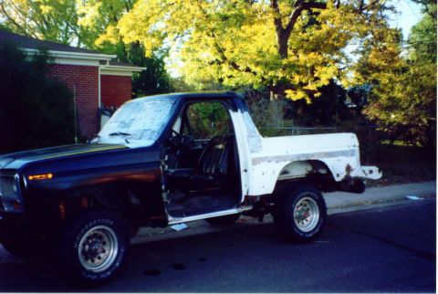 1981 Ford Bronco - This Ford Bronco appears to be undergoing some bodywork, with its doors open and parts of the body painted white.