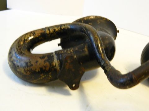 1915 Ford Model T - A close-up, angled view of a black, weathered metal horn assembly, likely from an antique vehicle. The horn has a curved, tubular shape wit…