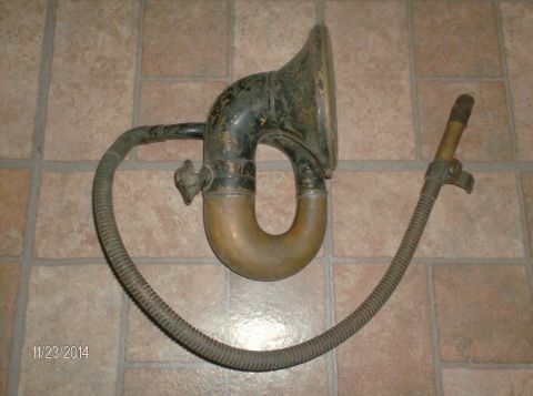 1915 Ford Model T - A vintage phonograph horn with a flexible tube and mouthpiece rests on a tiled floor. The date "11/23/2014" is visible in the lower left co…