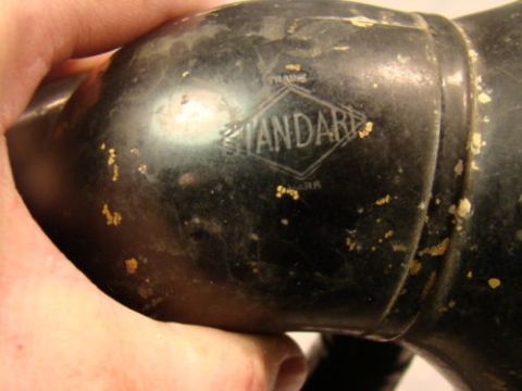 1915 Ford Model T - A close-up view of a black horn with a visible 'Standard' logo, showing signs of wear and paint chips.
